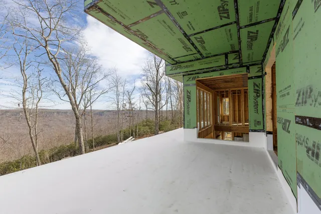 a view of a backyard with wooden fence