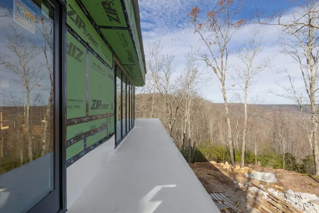 a view of a backyard with furniture and a yard
