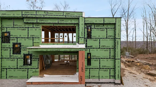 an aerial view of a house with a yard and mountain in the back