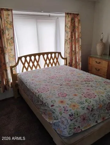 a bed sitting in a bedroom next to a window