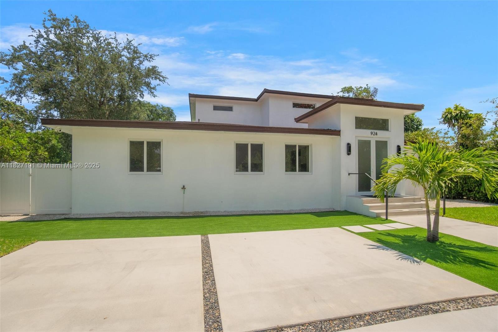 Biscayne Park Biscayne Park, FL 33161 - Photo 2 of 45 a front view of a house with a yard and garage