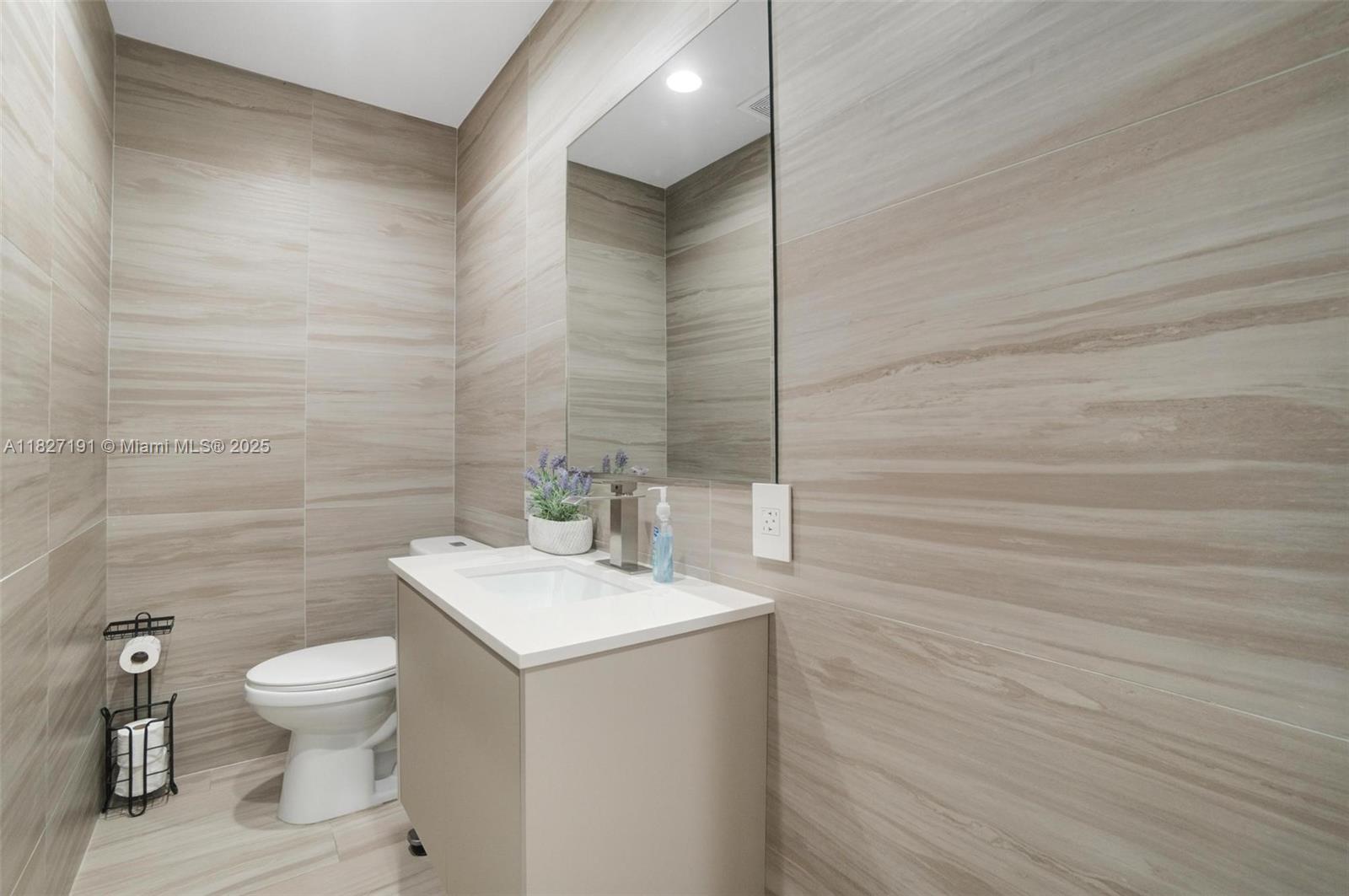 Biscayne Park Biscayne Park, FL 33161 - Photo 26 of 45 a bathroom with a toilet a sink and mirror