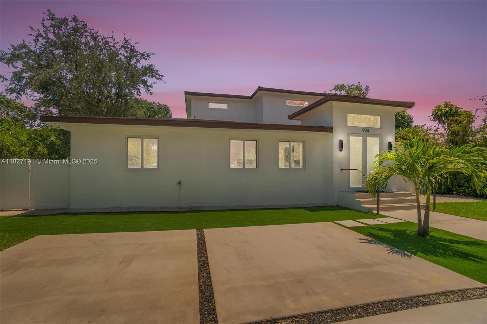 Biscayne Park Biscayne Park, FL 33161 - Photo 3 of 45 a front view of a house with a garden and yard