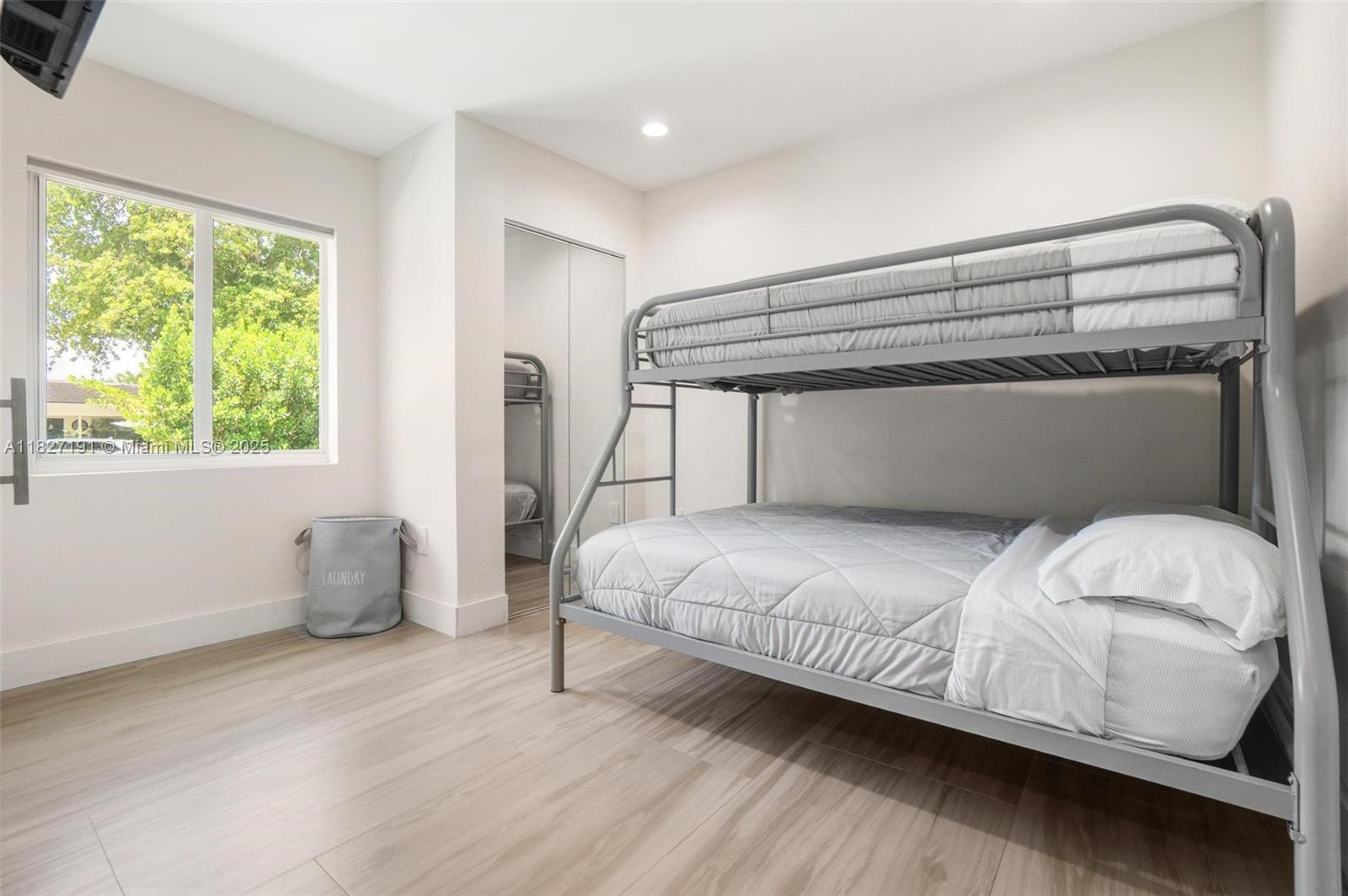 Biscayne Park Biscayne Park, FL 33161 - Photo 31 of 45 a bedroom with a bed and wooden floor