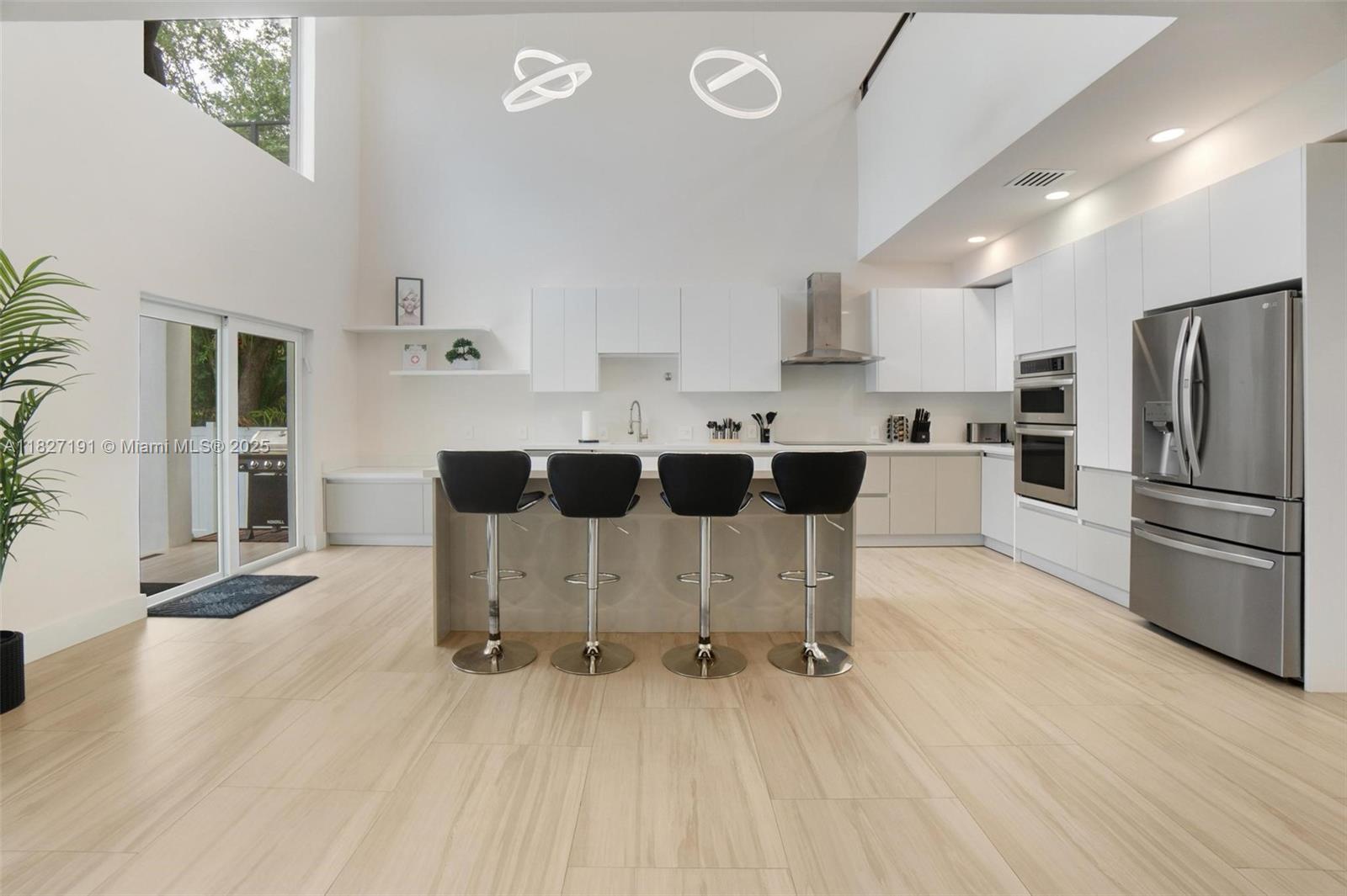 Biscayne Park Biscayne Park, FL 33161 - Photo 8 of 45 a kitchen with stainless steel appliances kitchen island granite countertop a refrigerator and a stove top oven