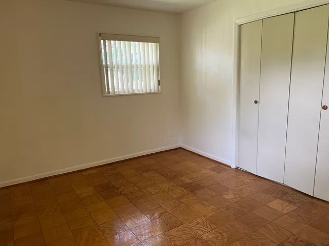 an empty room that has a window in it