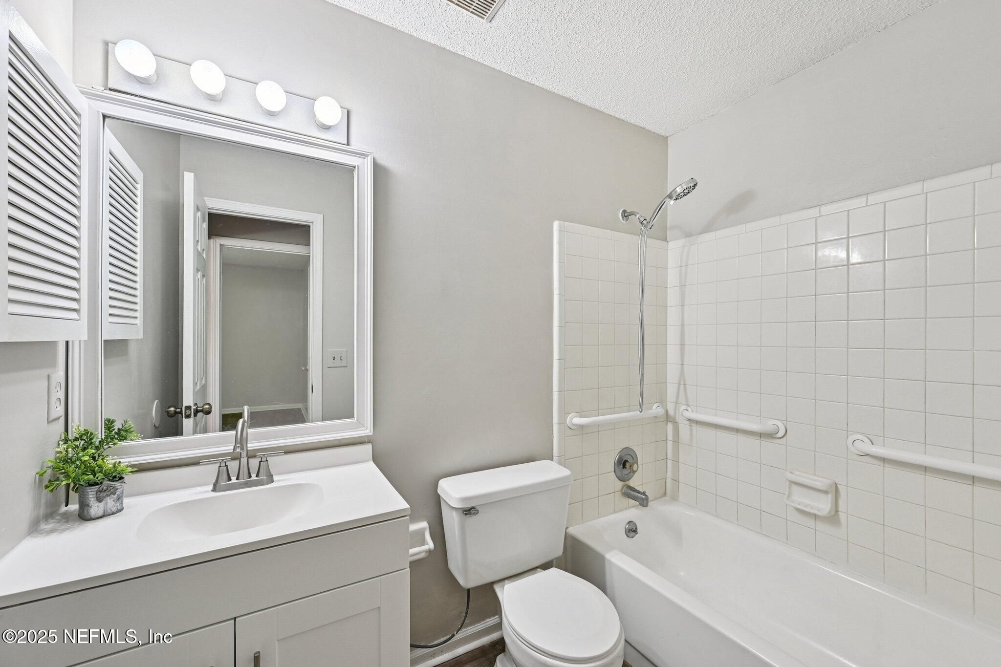3801 Crown Point Road, Unit 1174 Jacksonville, FL 32257 - Photo 11 of 17 a bathroom with a sink toilet a mirror and shower