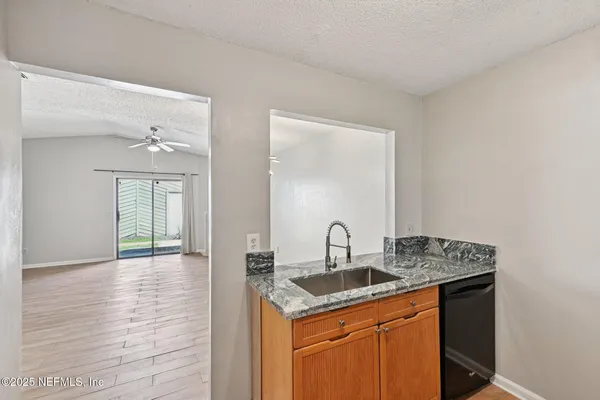 a kitchen with a sink cabinets and wooden floor