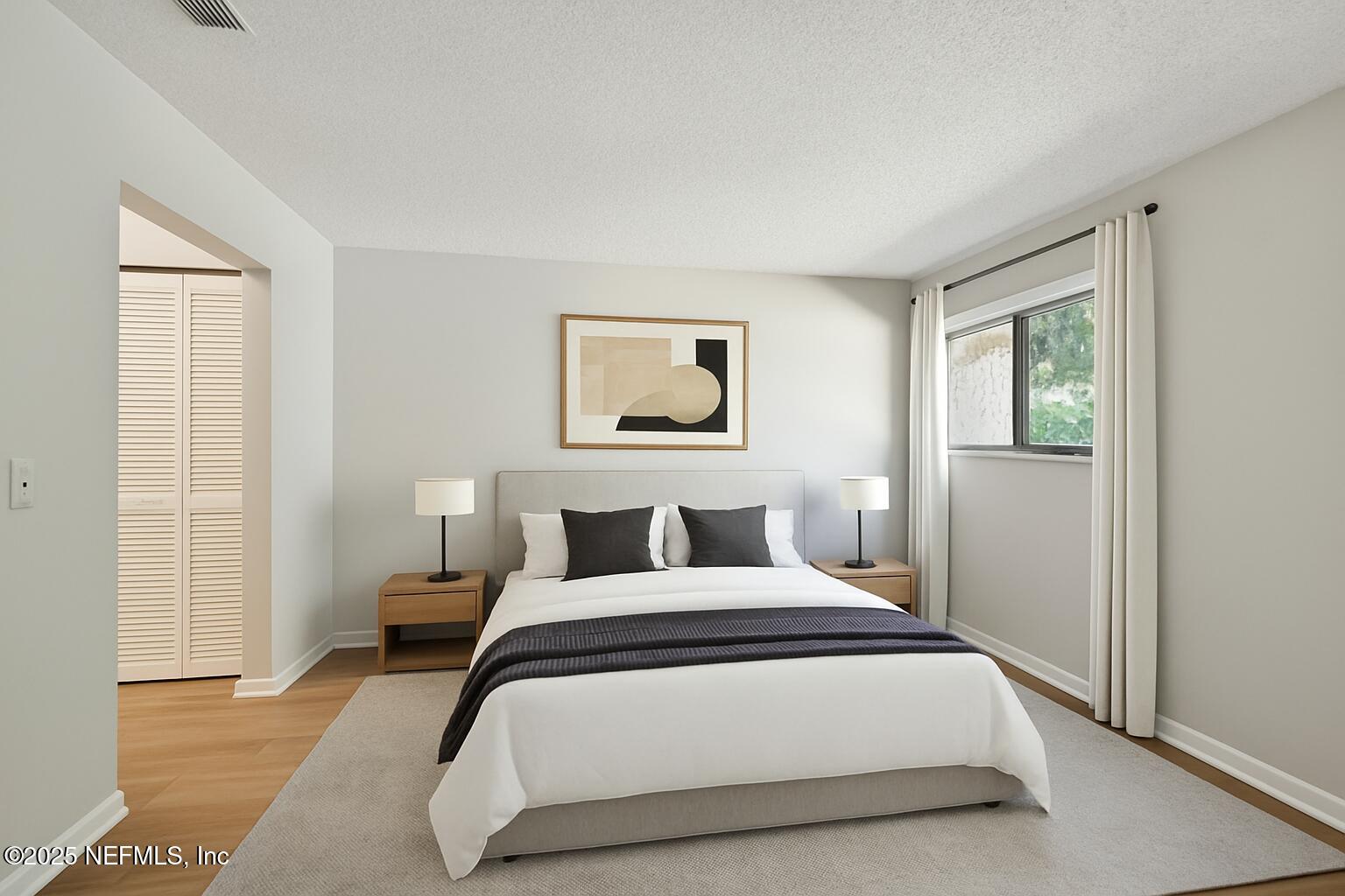 3801 Crown Point Road, Unit 1174 Jacksonville, FL 32257 - Photo 9 of 17 a bedroom with a large bed and a window