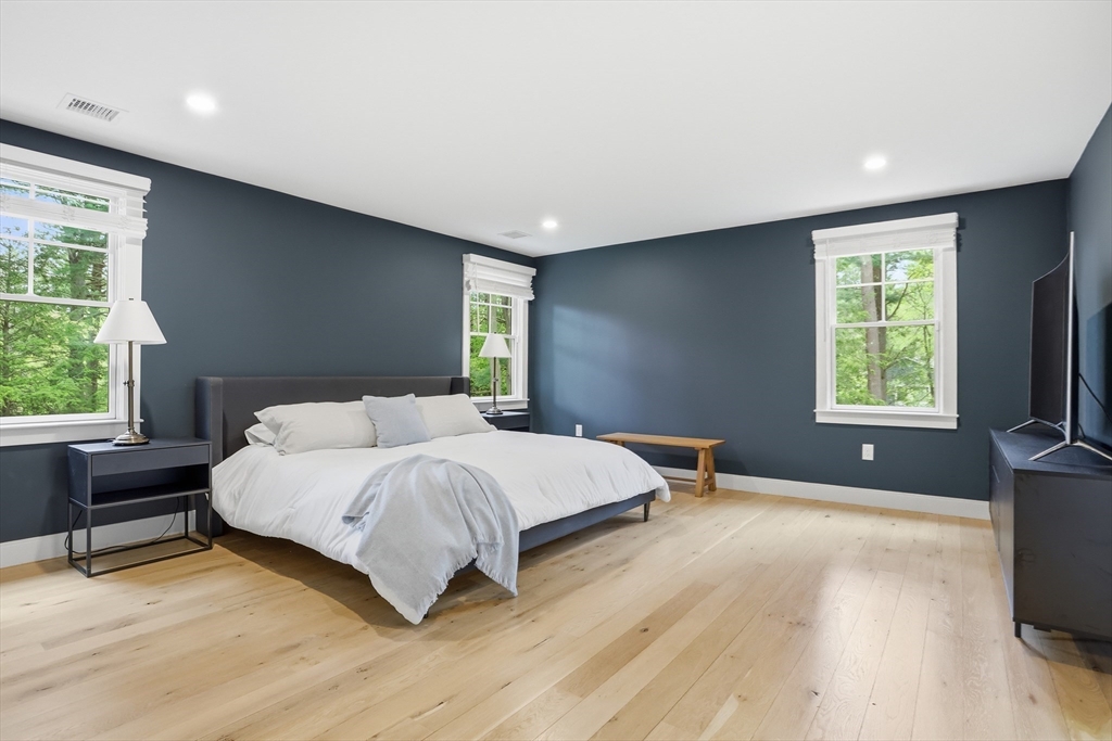 136 Holden Wood Road Concord, MA 01742 - Photo 14 of 31 a bedroom with a bed and a flat tv screen on the dresser