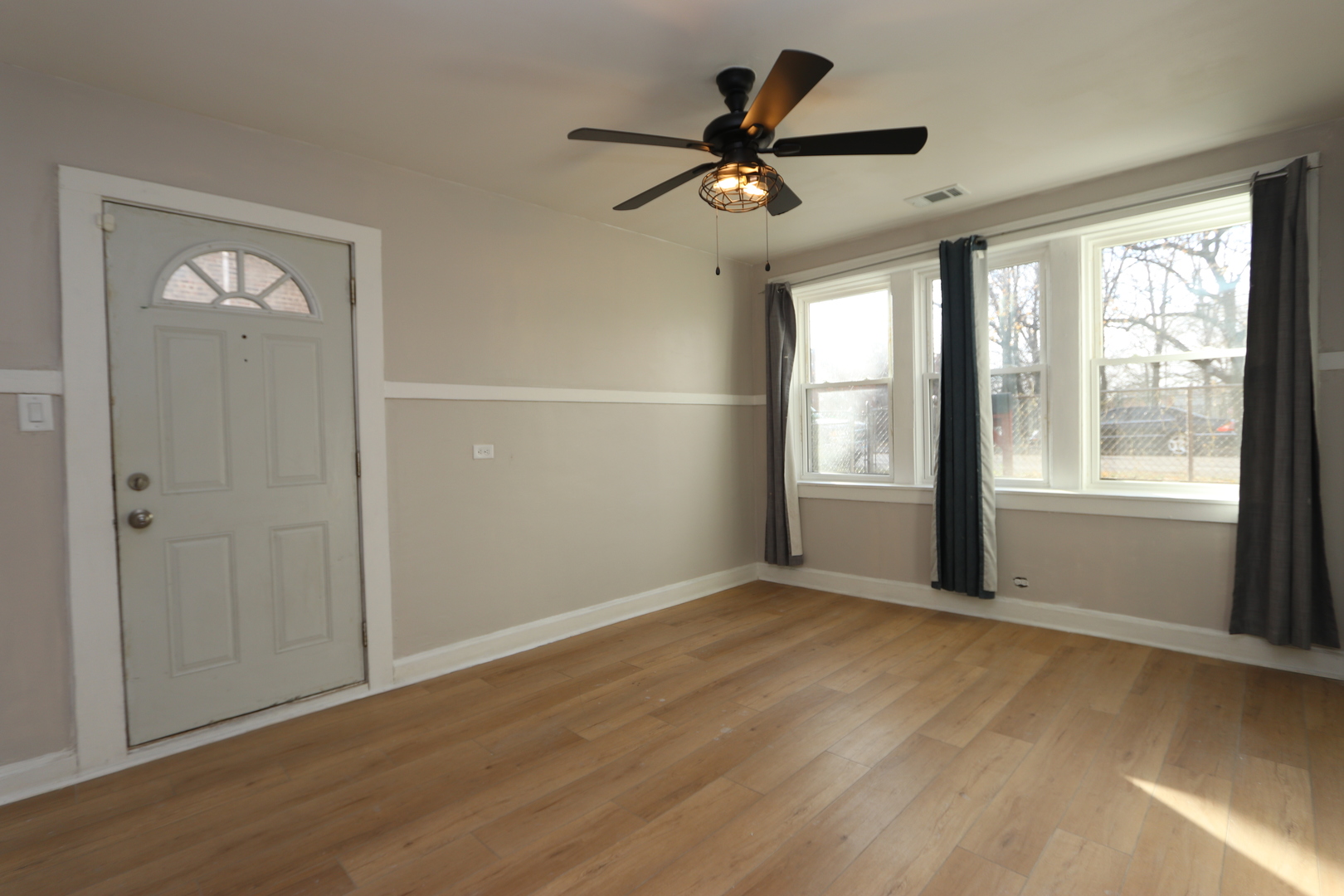 4621 South Laflin Street Chicago, IL 60609 - Photo 2 of 9 a view of a livingroom with a ceiling fan and window