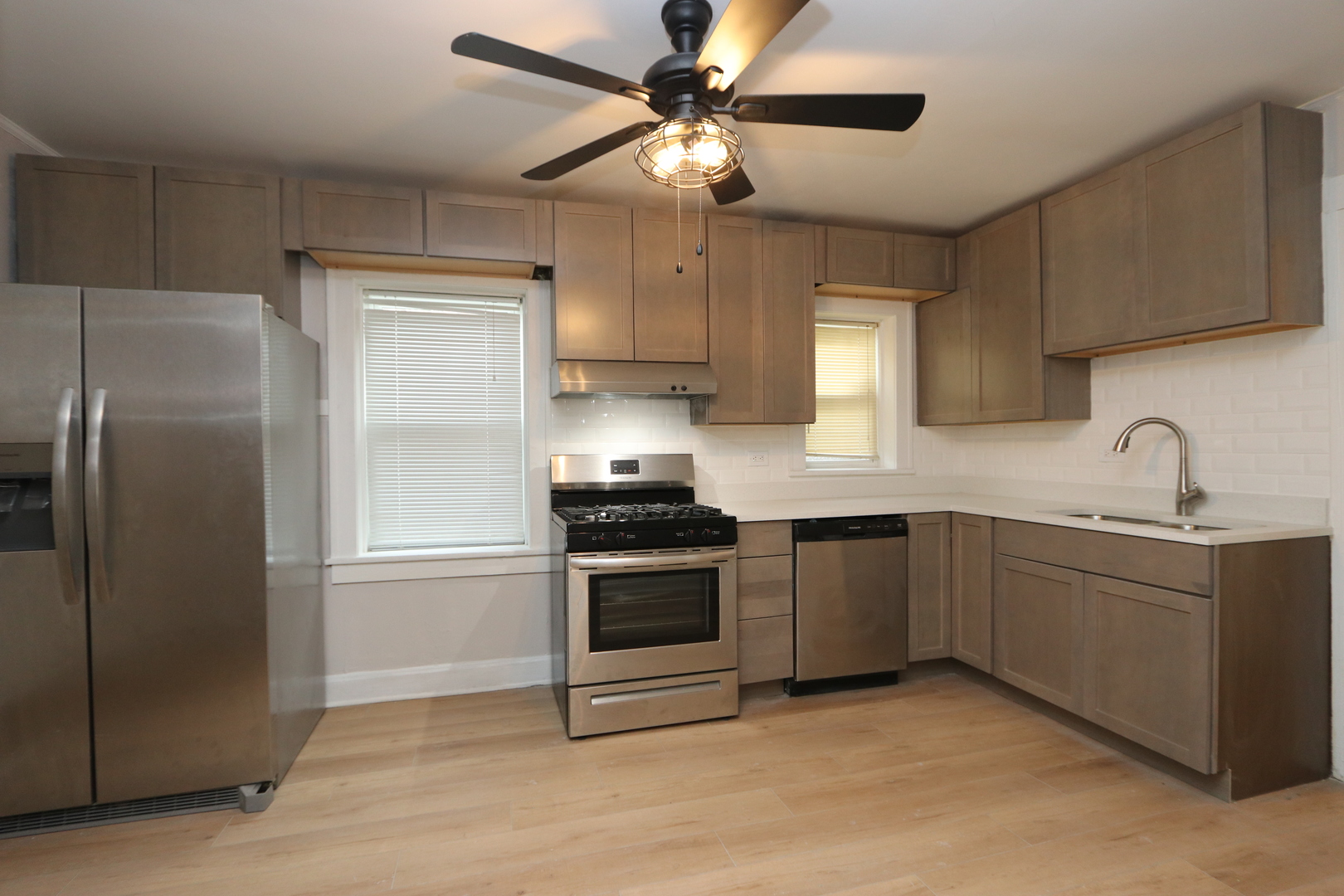 4621 South Laflin Street Chicago, IL 60609 - Photo 3 of 9 a kitchen with stainless steel appliances granite countertop a refrigerator a sink a stove and white cabinets