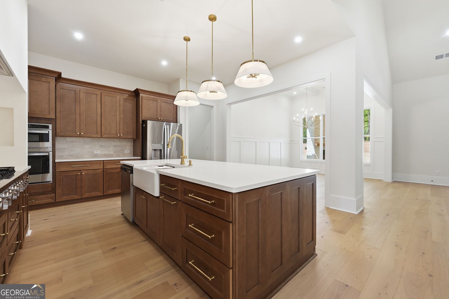 6625 Windvane Point Clermont, GA 30527 - Photo 12 of 45 a kitchen with a stove a sink a refrigerator and a counter top space