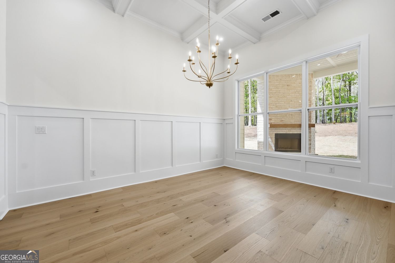 6625 Windvane Point Clermont, GA 30527 - Photo 19 of 45 wooden floor in an empty room with a window