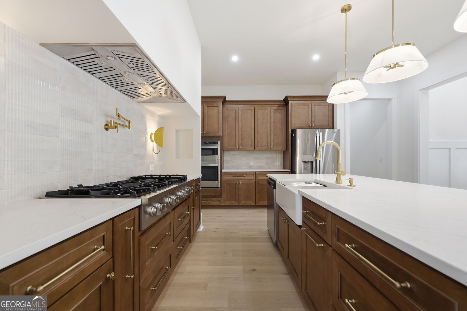 6625 Windvane Point Clermont, GA 30527 - Photo 23 of 45 a large kitchen with stainless steel appliances granite countertop a stove a sink and a microwave