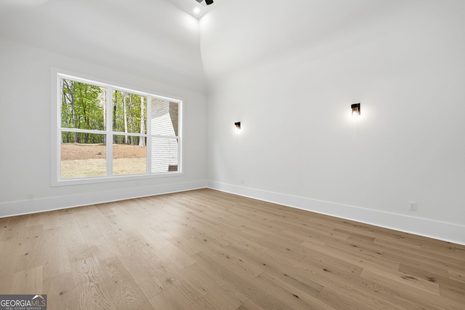 6625 Windvane Point Clermont, GA 30527 - Photo 25 of 45 a view of an empty room with wooden floor and a window