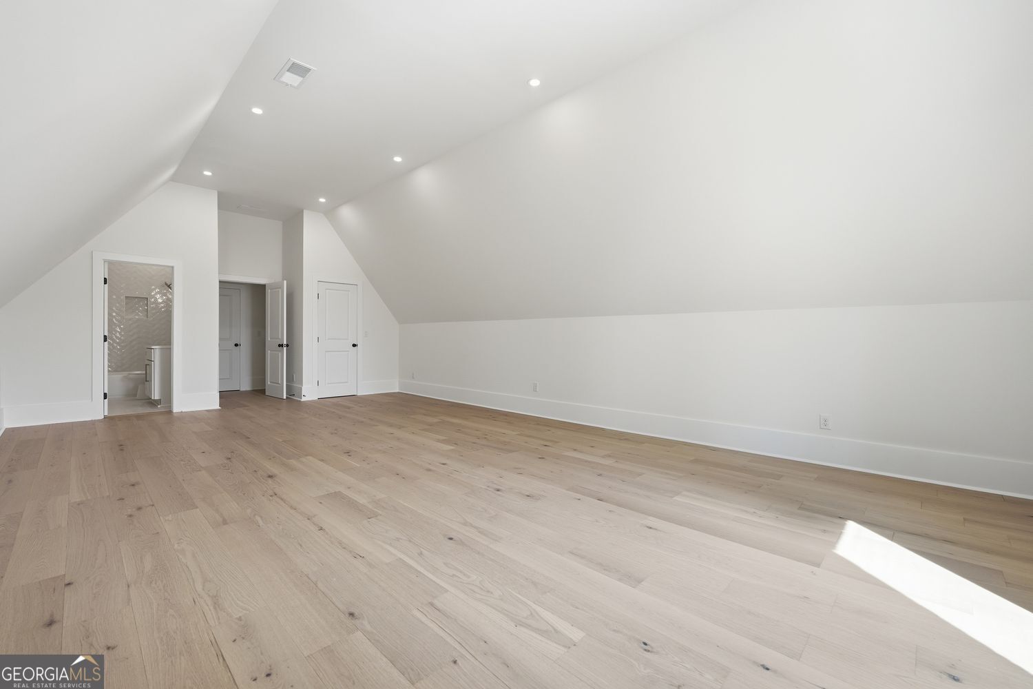 6625 Windvane Point Clermont, GA 30527 - Photo 35 of 45 an empty room with wooden floor and windows