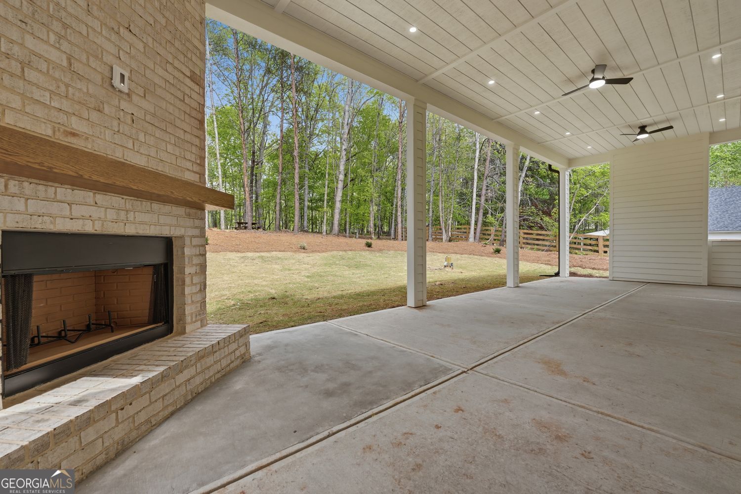 6625 Windvane Point Clermont, GA 30527 - Photo 43 of 45 a view of an empty room with wooden floor and a fireplace