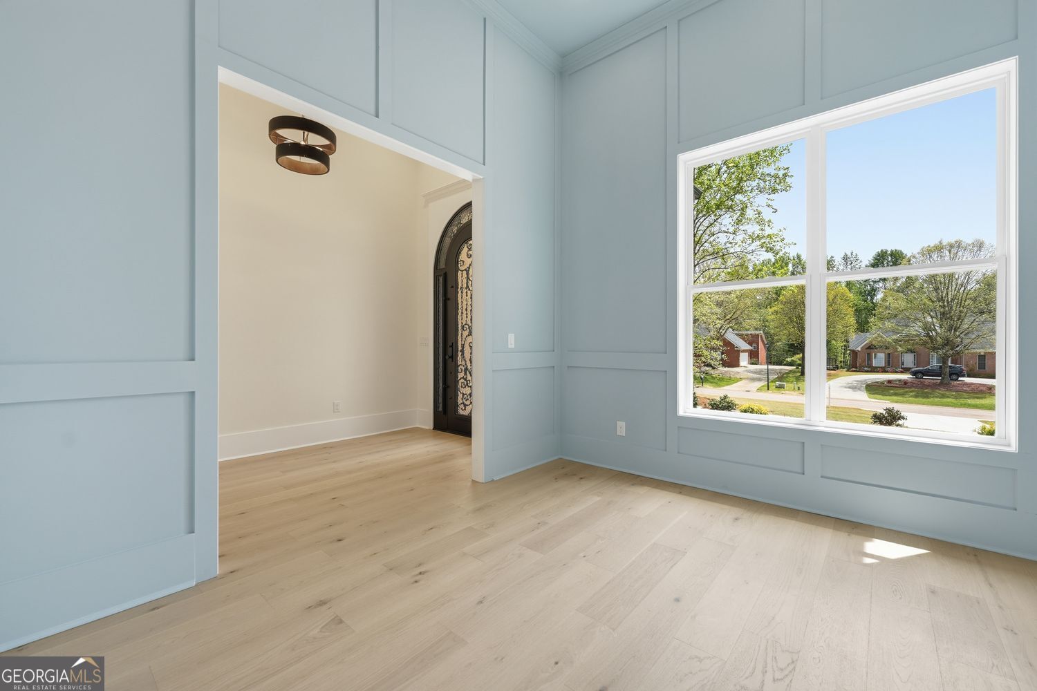 6625 Windvane Point Clermont, GA 30527 - Photo 8 of 45 an empty room with wooden floor and windows