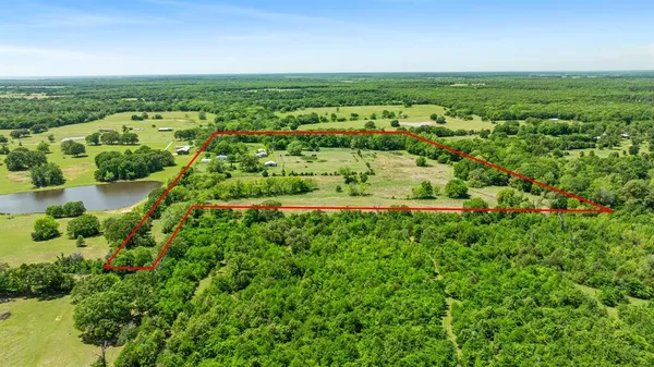 an aerial view of a houses with a yard
