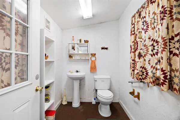 a kitchen with stainless steel appliances kitchen island granite countertop a sink a counter space cabinets and a stove