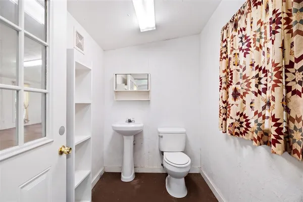 a large white kitchen with a stove a sink dishwasher and a refrigerator
