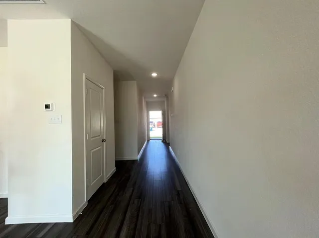 a view of a hallway view with wooden floor and staircase