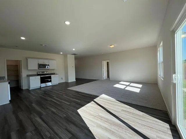a kitchen with granite countertop white cabinets and stainless steel appliances