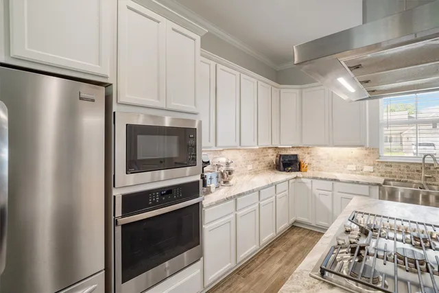 a kitchen with a sink stove and microwave