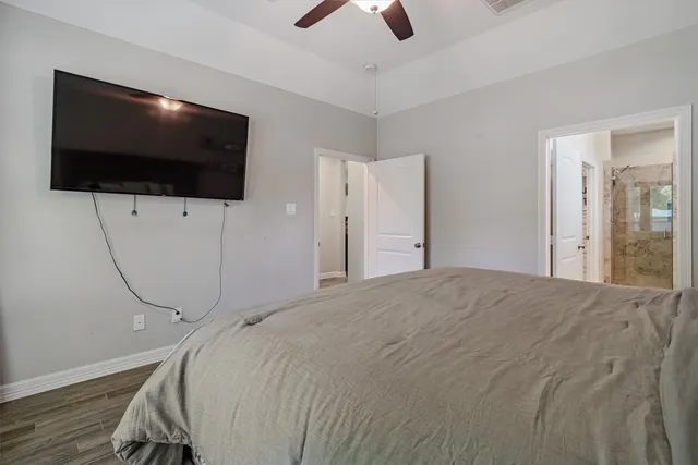 a bedroom with a bed and a flat screen tv