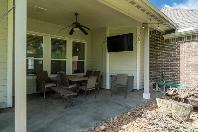 a balcony with furniture and a potted plant