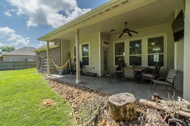 a view of a patio with table and chairs and potted plants