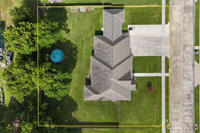 an aerial view of a house with a yard