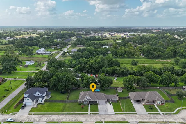 an aerial view of house with yard swimming pool and outdoor seating