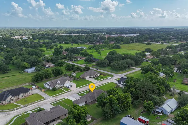 an aerial view of a city with lots of residential buildings ocean and mountain view in back