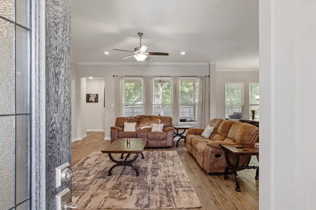 a living room with furniture and wooden floor