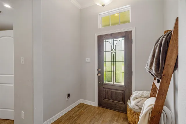a view of a bedroom with bed and wooden floor