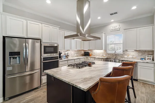 a kitchen with a refrigerator a stove a sink and a refrigerator