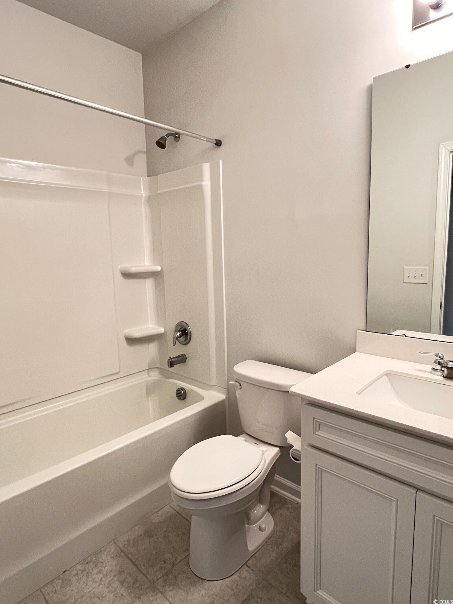3320 Candytuft Drive Conway, SC 29526 - Photo 11 of 19 Bathroom featuring vanity, shower / tub combination, and dark tile patterned floors