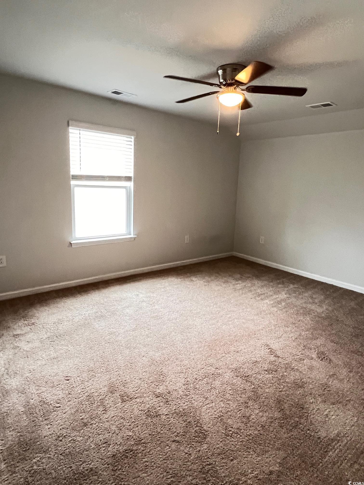 3320 Candytuft Drive Conway, SC 29526 - Photo 17 of 19 Carpeted spare room with a textured ceiling and a ceiling fan