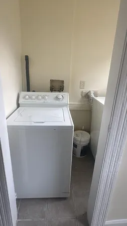 a utility room with a sink washer and dryer