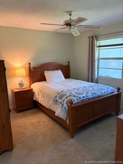 1953 Southwest Palm City Road, Unit G Stuart, FL 34994 - Photo 17 of 37 Comfortable-sized primary bedroom with plenty of room for a king-size bed and accompanying furniture
Large windows provide abundant natural light
Beautiful views across the manicured green space and golf-course setting
The bedroom appears to have a pleasant, open outlook rather than facing another building directly
Neutral carpeting and soft, light-colored walls create a calm, comfortable atmosphere
Ceiling fan for additional comfort
Two windows provide both light and a nice connection to the outdoors