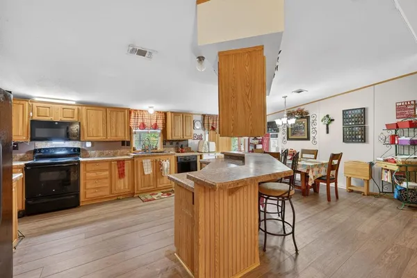 a kitchen with cabinets a sink and appliances