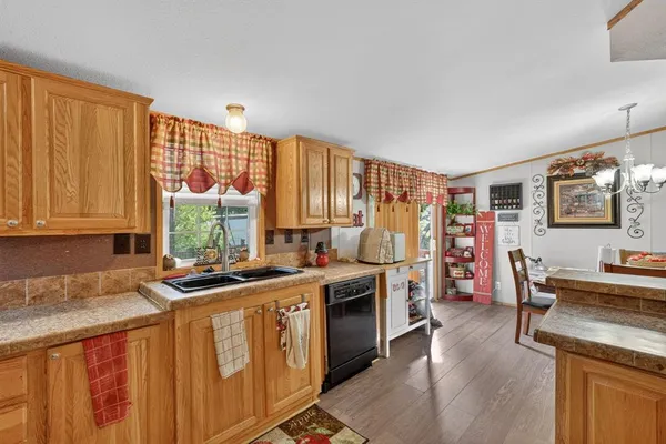 a kitchen with stainless steel appliances a stove a sink dishwasher and a refrigerator