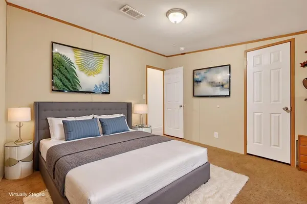 a bedroom with a large bed and a painting on the wall