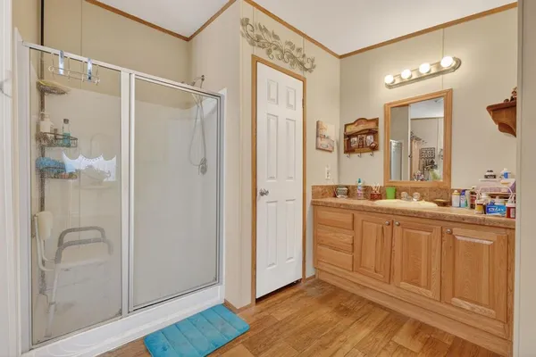 a spacious bathroom with a shower sink and mirror