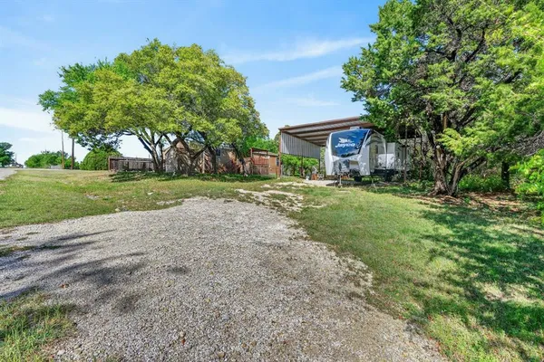 a view of a house with a yard and tree s