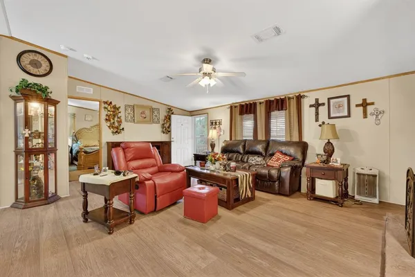 a living room with furniture gym equipment and a large window