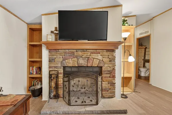 a living room with a fireplace and a flat screen tv