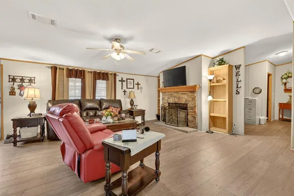 a living room with furniture a fireplace and a flat screen tv